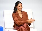 As she balances personal and professional responsibilities, Meghan's upcoming projects, including a podcast and cooking show, could reshape public perceptions in 2025. (Photo by Raul ARBOLEDA / AFP)