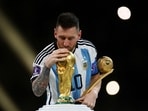 Argentina's Lionel Messi kisses the World Cup trophy after receiving the Golden Ball award as he celebrates after winning the 2022 World Cup.