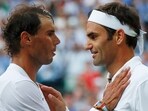 Roger Federer shakes hands and embraces Spain's Rafael Nadal.