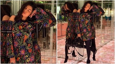 Radiating total trendy vibes, Sushmita stuns in a black cold-shoulder dress adorned with vibrant floral prints. Paired with stockings and a chic Gucci bag, she serves major fashion goals. (Instagram) Radiating total trendy vibes, Sushmita stuns in a black cold-shoulder dress adorned with vibrant floral prints. Paired with stockings and a chic Gucci bag, she serves major fashion goals. (Instagram)
