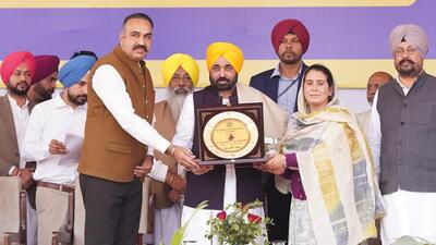 DC Sandeep Rishi and MLA Narinder Kaur Bharaj presenting a memento to CM Bhagwant Mann in Sangrur on Tuesday. (HT Photo)