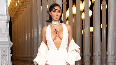 Kim Kardashian attended the 2024 LACMA Art + Film Gala in a plunging white gown styled with a floor-sweeping cape (REUTERS)
