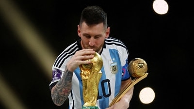 Argentina's Lionel Messi kisses the World Cup trophy after receiving the Golden Ball award as he celebrates after winning the 2022 World Cup. (Reuters)