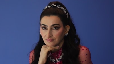 In this look, Shalini Passi dazzles in a magenta dress from Jenny Packham with sheer cape sleeves, exuding timeless grace