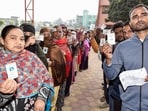 Voters show their IDs while waiting in queues to cast their vote for the second and final phase of the Jharkhand assembly election. Voters show their IDs while waiting in queues to cast their vote for the second and final phase of the Jharkhand assembly election.