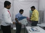 Election officials make preparations at a polling station on the day of the Maharashtra state elections, in Mumbai, India. 