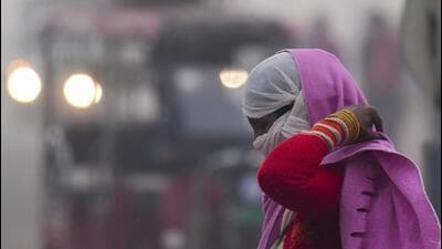 A woman covers her face on a cold and smoggy morning in New Delhi. (PTI Photo) A woman covers her face on a cold and smoggy morning in New Delhi. (PTI Photo)