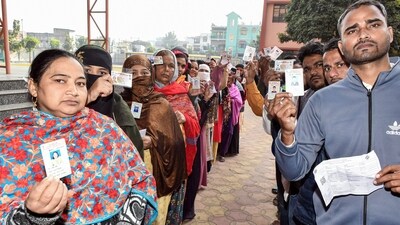 Voters show their IDs while waiting in queues to cast their vote for the second and final phase of the Jharkhand assembly election. (ANI)
