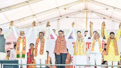 Dhule [Maharashtra], Nov 08 (ANI): Prime Minister Narendra Modi along with Maharashtra Dy CM Devendra Fadnavis, Bharatiya Janata Party (BJP) Dhule seat candidate Anup Agarwal and others hold hands during a public meeting for the Maharashtra Assembly elections, in Dhule on Friday. (ANI Photo) (Narendra Modi Website)