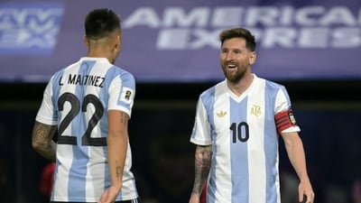 Lautaro Martinez celebrates with Argentina's forward Lionel Messi after scoring during the 2026 FIFA World Cup South American qualifiers against Peru. (AFP)