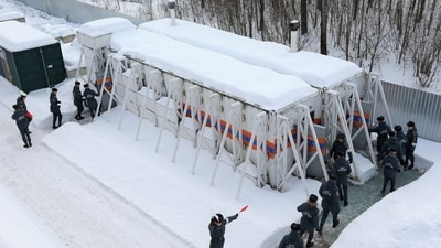 Emergency personnel walk into radiation-resistant mobile bomb shelters in Nizhny Novgorod region. (via REUTERS)
