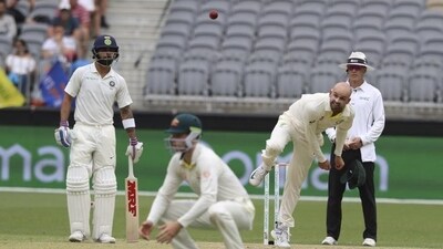 Australia's Nathan Lyon bowls, watched by India's Virat Kohli (left) (AP) Australia's Nathan Lyon bowls, watched by India's Virat Kohli (left) (AP)