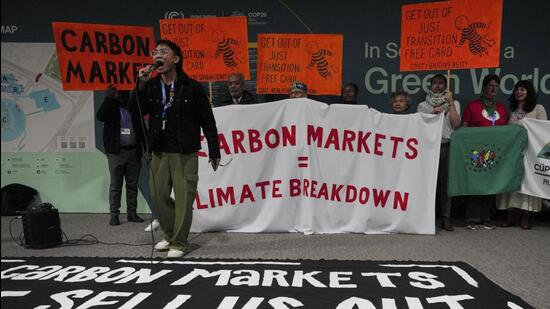 Activists participate in a demonstration against carbon markets at the COP29 UN Climate Summit in Baku, Azerbaijan, on Wednesday. (AP)