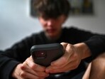 A teenager uses his mobile phone to access social media, Sydney, Wednesday, Nov. 13, 2024. (Dean Lewins/AAP Image VIA AP)