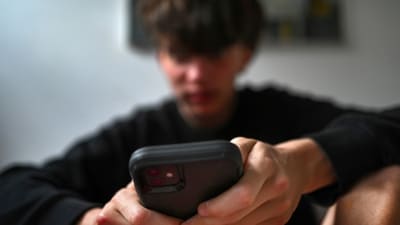 A teenager uses his mobile phone to access social media, Sydney, Wednesday, Nov. 13, 2024. (Dean Lewins/AAP Image VIA AP)