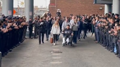 Hero NYPD cop Rich Wong leaving hospital met with applause after killing career criminal despite being shot (@NYCPBA/X)