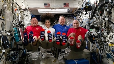 In this photo provided by NASA, from left, astronauts Butch Wilmore, Suni Williams, Nick Hague and Don Pettit show their U.S. flag-themed socks aboard the International Space Station on Election Day, Tuesday, Nov. 5, 2024. (AP) In this photo provided by NASA, from left, astronauts Butch Wilmore, Suni Williams, Nick Hague and Don Pettit show their U.S. flag-themed socks aboard the International Space Station on Election Day, Tuesday, Nov. 5, 2024. (AP)
