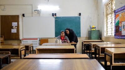 School teachers conduct online classes using a mobile phone in an empty classroom after schools were ordered shut by the Delhi government as Delhi's air quality worsened. REUTERS (REUTERS)