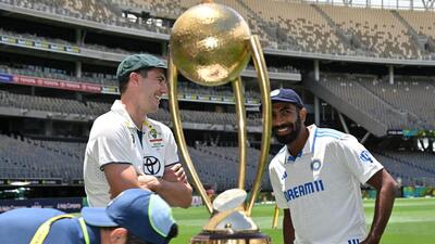 India captain Jasprit Bumrah and Australia captain Pat Cummins pose with the Border Gavaskar Trophy at Optus Stadium in Perth on Thursday. (AFP) India captain Jasprit Bumrah and Australia captain Pat Cummins pose with the Border Gavaskar Trophy at Optus Stadium in Perth on Thursday. (AFP)