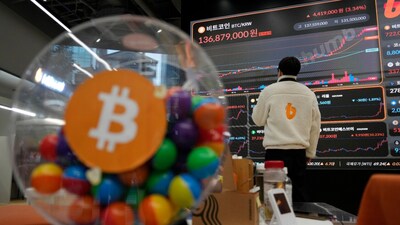 An employee watches an electronic signboard displaying the prices of Bitcoin and other cryptocurrencies at the lounge of Bithumb cryptocurrency exchange in Seoul, South Korea, Thursday. (AP)