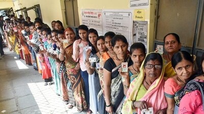 Voters wait in queues to cast their vote for the Maharashtra assembly elections, in Akola on Wednesday. (ANI)