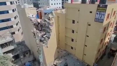 A building in Hyderabad began to tilt to its side, leading to its demolition (X/@sudhakarudumula)