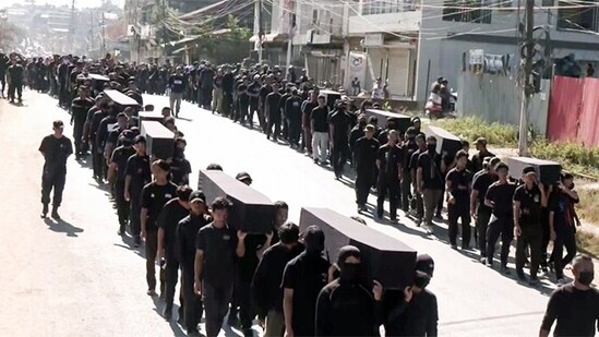 Members of Kuki organisations hold a rally carrying mock 'coffins' in remembrance of the deceased members of their community who died during unrest in the Manipur (ANI Photo) (ANI)