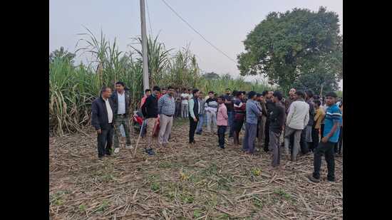 Forest officials and villagers at the spot where a tiger killed a farmer on Thursday. (HT Photo)