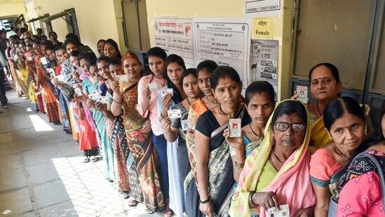 Voters wait in queues to cast their vote for the Maharashtra assembly elections, in Akola on Wednesday. (ANI)