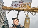 A farmer holds a placard reading "The Last Straw" during a demonstration by farmers over inheritance tax changes, in London, UK, on November 19. (Bloomberg) A farmer holds a placard reading "The Last Straw" during a demonstration by farmers over inheritance tax changes, in London, UK, on November 19. (Bloomberg)