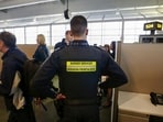 Canada Border Services Agency (CBSA) officer watches during a tour of the Infield Terminal, at Toronto Pearson International Airport.