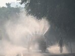 A tanker sprays water on roads to settle air pollution in Noida, which neighbours Delhi. A tanker sprays water on roads to settle air pollution in Noida, which neighbours Delhi.
