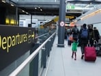 Passengers pull luggage after disembarking an inter-terminal train at London Gatwick Airport. Passengers pull luggage after disembarking an inter-terminal train at London Gatwick Airport.
