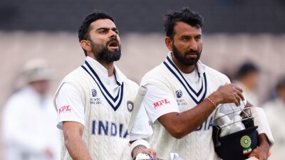 India's Virat Kohli and Cheteshwar Pujara walk off (Action Images via Reuters)