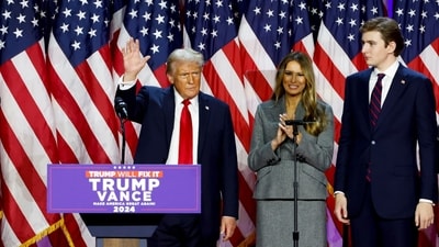 Former US President Donald Trump, from left, former US First Lady Melania Trump, and their son Barron Trump during an election night event at the Palm Beach Convention Center in West Palm Beach, Florida, US, on Wednesday, Nov. 6, 2024.. Photographer: Eva Marie Uzcategui/Bloomberg (Bloomberg) Former US President Donald Trump, from left, former US First Lady Melania Trump, and their son Barron Trump during an election night event at the Palm Beach Convention Center in West Palm Beach, Florida, US, on Wednesday, Nov. 6, 2024.. Photographer: Eva Marie Uzcategui/Bloomberg (Bloomberg)