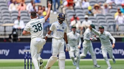 Australia's Josh Hazlewood celebrates the wicket of India's Devdutt Padikkal. (AP) Australia's Josh Hazlewood celebrates the wicket of India's Devdutt Padikkal. (AP)