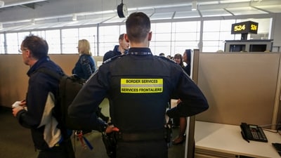 Canada Border Services Agency (CBSA) officer watches during a tour of the Infield Terminal, at Toronto Pearson International Airport. (REUTERS)
