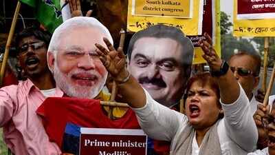 Congress party workers protest against Prime Minister Narendra Modi and billionaire businessman Gautam Adani in Kolkata on Friday. (AFP) Congress party workers protest against Prime Minister Narendra Modi and billionaire businessman Gautam Adani in Kolkata on Friday. (AFP)