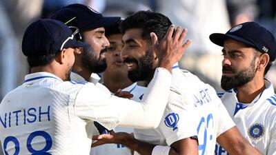 India’s KL Rahul and Viral Kohli embrace team’s skipper Jasprit Bumrah after dismissal of Australia’s Pat Cummins during the first day of the first Test against Australia at the Optus Stadium in Perth on Friday. (AFP) India’s KL Rahul and Viral Kohli embrace team’s skipper Jasprit Bumrah after dismissal of Australia’s Pat Cummins during the first day of the first Test against Australia at the Optus Stadium in Perth on Friday. (AFP)