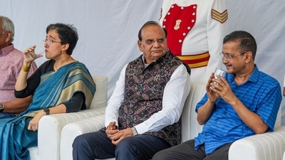 Delhi Lt. Governor VK Saxena with former chief minister Arvind Kejriwal and Delhi CM-designate Atishi. (PTI) Delhi Lt. Governor VK Saxena with former chief minister Arvind Kejriwal and Delhi CM-designate Atishi. (PTI)