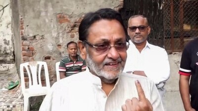 Mumbai: NCP leader Nawab Malik shows his ink-marked finger after casting vote. (PTI file photo)