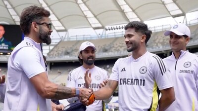 Virat Kohli hands Nitish Kumar Reddy his debut cap in Perth (BCCI) Virat Kohli hands Nitish Kumar Reddy his debut cap in Perth (BCCI)