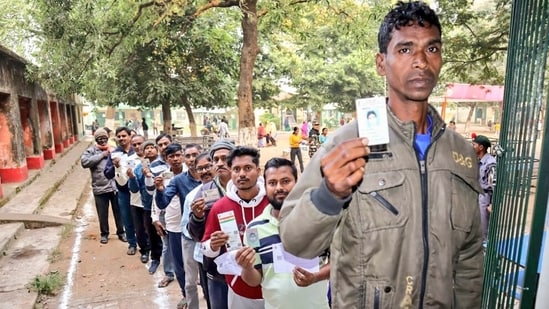 Voters in Bokaro wait with their IDs in a queue outside a polling station  during the 2024 Jharkhand polls. (ANI)