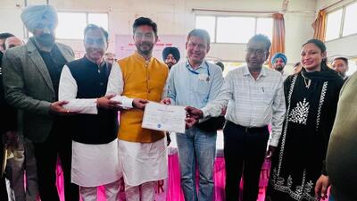 AAP’ s victorious candidate Ishank Kumar getting the winner certificate from the returning officer at Chabbewal on Saturday. (HT Photo)