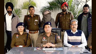 Lovepreet Singh, alias Monu, alias Baba, in police custody in Ludhiana on Saturday. (HT Photo)