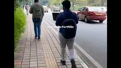 A Bengaluru man attended a meeting while walking on the road, sparking mixed reactions. (X/@karnatakaportf) A Bengaluru man attended a meeting while walking on the road, sparking mixed reactions. (X/@karnatakaportf)
