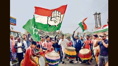 Supporters of the Jharkhand Mukti Morcha and Congress celebrate in Ranchi on Saturday. (PTI)