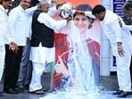 Senior Congress leader V. Hanumantha Rao with other party leaders pour milk on a portrait of Priyanka Gandhi Vadra following her win in the Wayanad Lok Sabha by-polls.