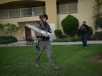 An Israeli bomb squad policeman carries the remains of a rocket that was fired from Lebanon in Kibbutz Kfar Blum, northern Israel Sunday Nov. 24, 2024. An Israeli bomb squad policeman carries the remains of a rocket that was fired from Lebanon in Kibbutz Kfar Blum, northern Israel Sunday Nov. 24, 2024.