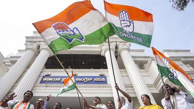 Bengaluru: Congress party workers celebrate after the party's win all three assembly by-elections in Bengaluru Saturday (PTI)